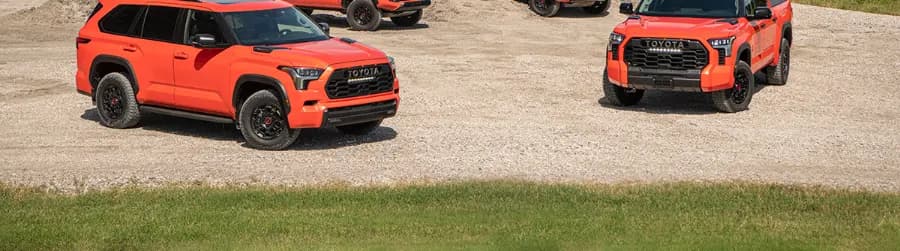 Orange Toyota SUVs on gravel